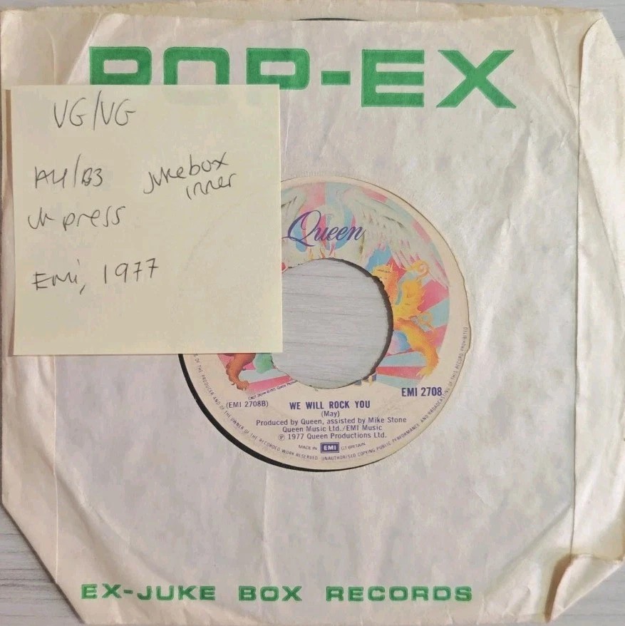 Queen We Are The Champions / We Will Rock You Vinyl Record 7" VG/VG EMI2708 1977 sleeve Queen We Are The Champions / We Will Rock You Vinyl Record 7" VG/VG EMI2708 1977 sleeve